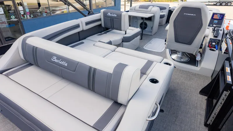 Slide: The Image of 2025 Barletta Corsa 23U pontoon boat interior with luxurious seating and modern helm. - 8