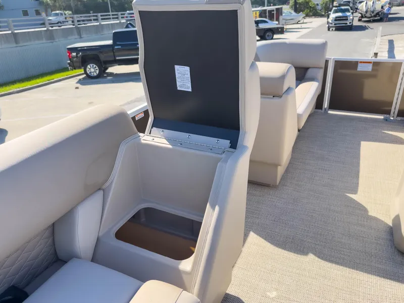 Slide: The Image of 2024 Bennington 188 SL boat interior with open storage compartment and beige seating. - 15