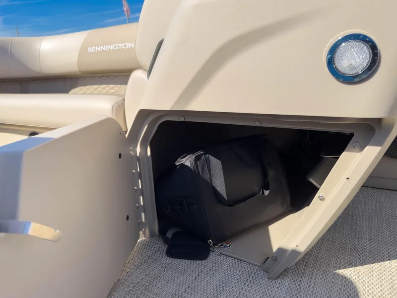 Slide: The Image of Open storage compartment on a 2024 Bennington 188 SL boat, showing interior space. - 22