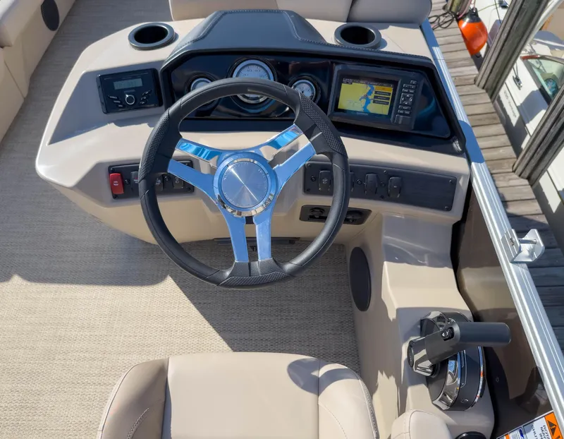 Slide: The Image of 2024 Bennington 188 SL boat dashboard with steering wheel and navigation system. - 24