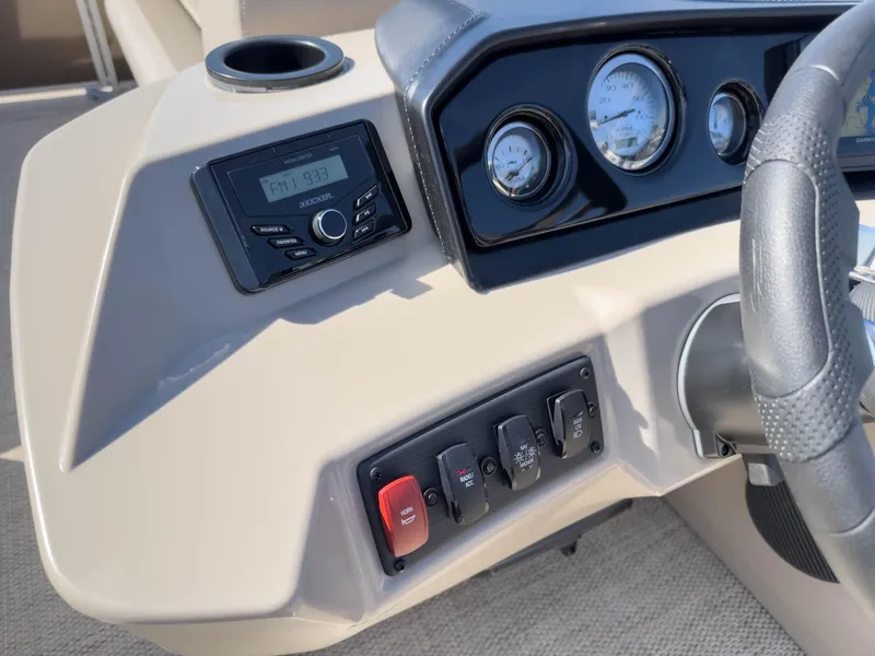 Slide: The Image of 2024 Bennington 188 SL dashboard with radio, gauges, and control switches. - 25