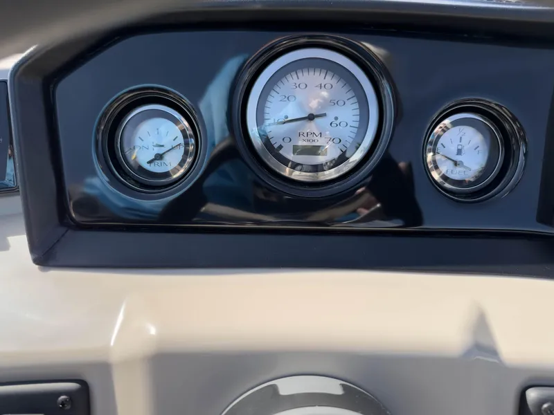 Slide: The Image of Dashboard gauges of 2024 Bennington 188 SL boat, showing RPM, trim, and fuel levels. - 26