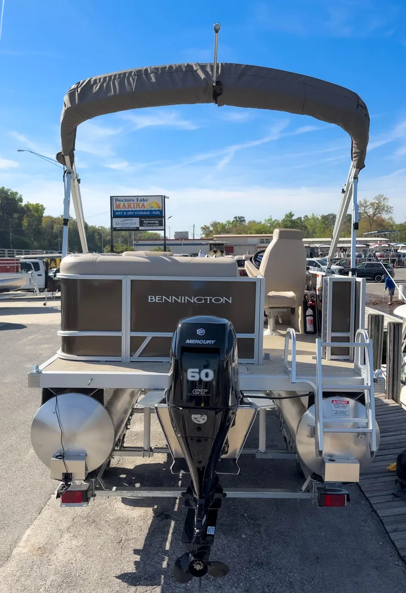 Slide: The Image of 2024 Bennington 188 SL pontoon boat with Mercury 60 engine at marina dock. - 7