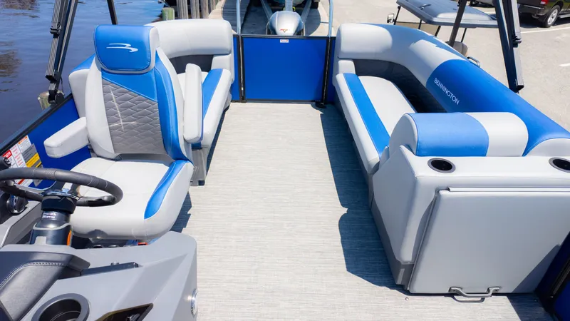 Slide: The Image of 2024 Bennington 20 SSR pontoon boat interior with blue and gray seating. - 11