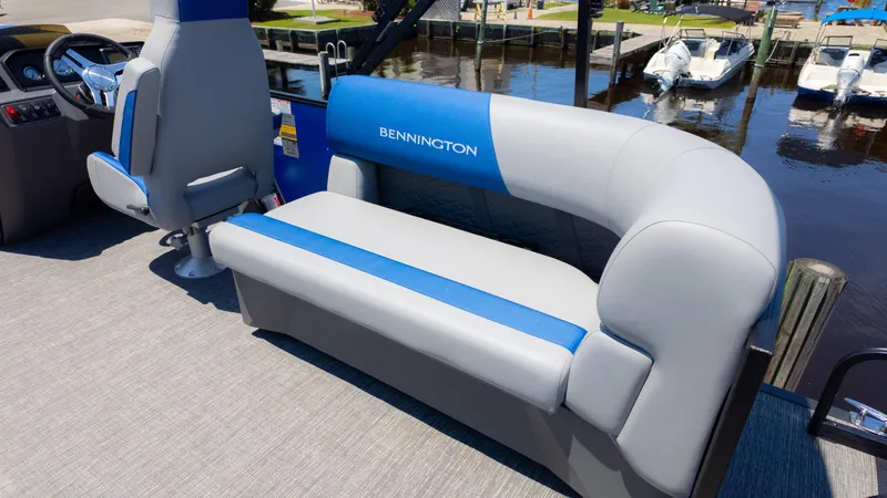 Slide: The Image of 2024 Bennington 20 SSR pontoon boat interior with blue and gray seating. - 12