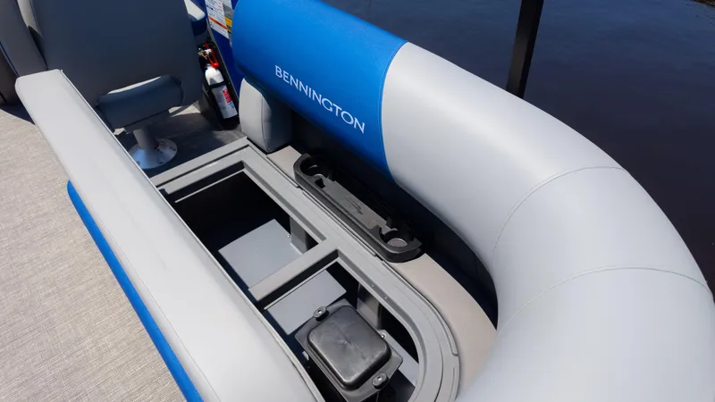 Slide: The Image of 2024 Bennington 20 SSR boat interior with open storage compartment and seating. - 13