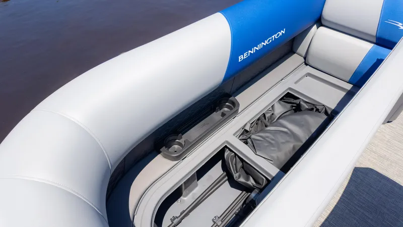 Slide: The Image of 2024 Bennington 20 SSR boat interior with storage compartment and cushioned seating. - 23