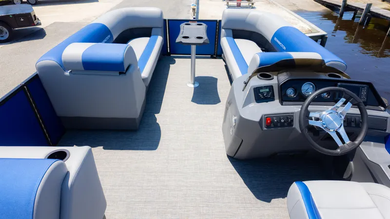 Slide: The Image of 2024 Bennington 20 SSR pontoon boat interior with blue and gray seating and steering console. - 8