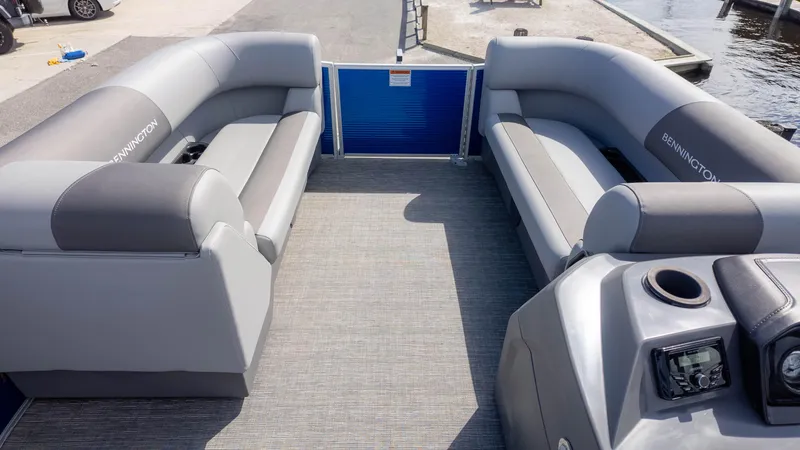 Slide: The Image of 2025 Bennington 20 SVS Stern Fish boat interior with gray seating and control panel. - 10