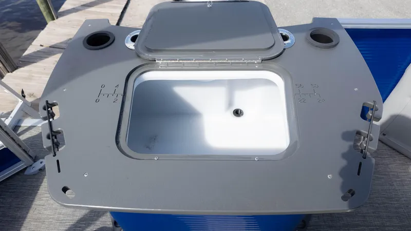 Slide: The Image of 2025 Bennington 20 SVS Stern Fish boat's livewell with open lid and cup holders. - 13