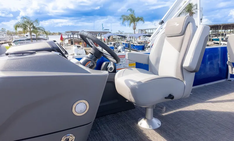 Slide: The Image of 2025 Bennington 20 SVS Stern Fish boat interior with captain's chair and steering wheel. - 21