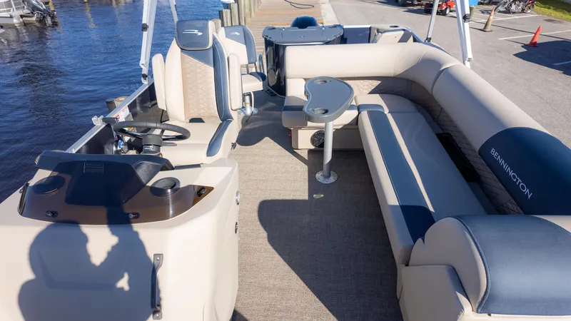 Slide: The Image of 2025 Bennington 21 SF pontoon boat interior with seating and steering console. - 11