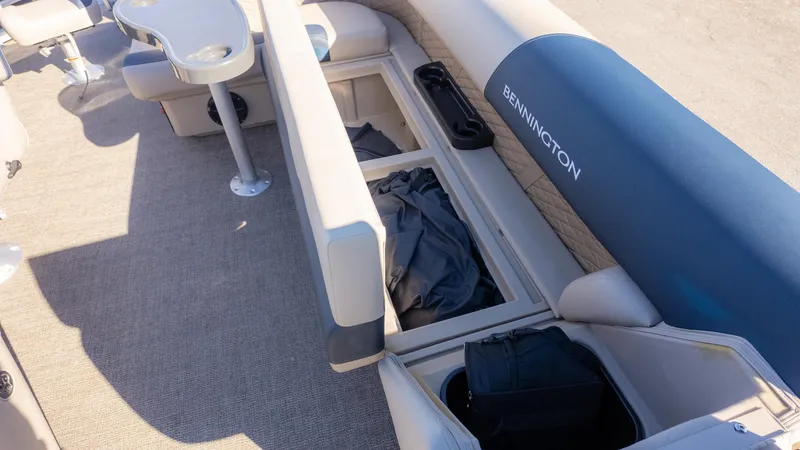 Slide: The Image of 2025 Bennington 21 SF boat interior with storage compartments and seating. - 17