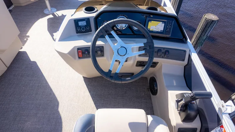 Slide: The Image of 2025 Bennington 21 SF boat dashboard with steering wheel and navigation controls. - 24