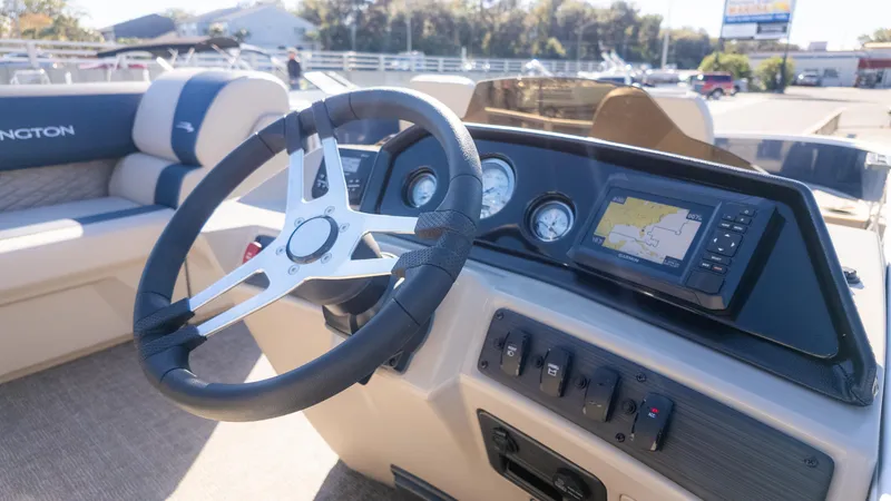 Slide: The Image of 2025 Bennington 21 SF boat dashboard with steering wheel and navigation display. - 26
