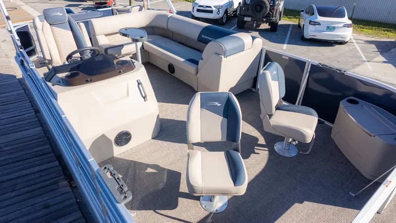 Slide: The Image of 2025 Bennington 21 SF pontoon boat interior with seating and steering console. - 4
