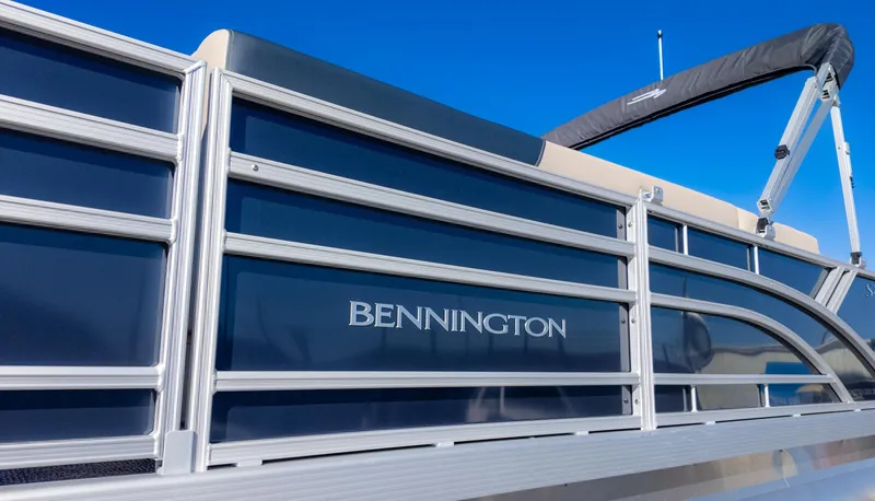 Slide: The Image of 2025 Bennington 21 SF pontoon boat with sleek design against clear blue sky. - 8