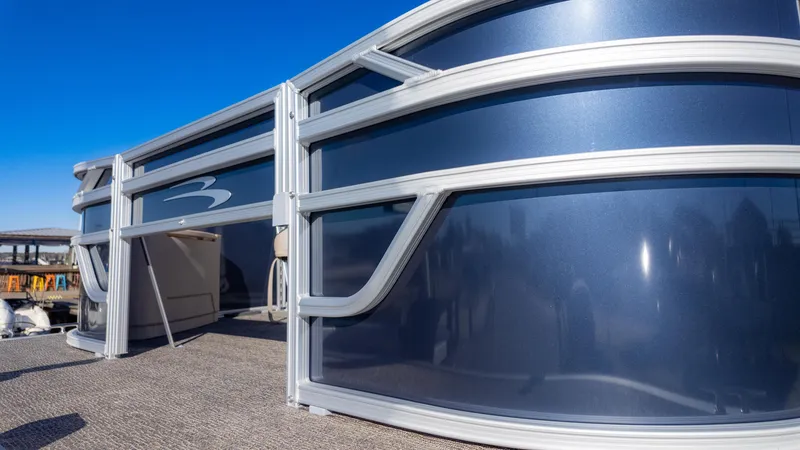 Slide: The Image of 2025 Bennington 21 SF pontoon boat with sleek blue exterior and modern design. - 9