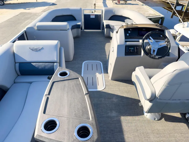 Slide: The Image of 2024 Bennington 22 LSB pontoon boat interior with plush seating and modern helm. - 10