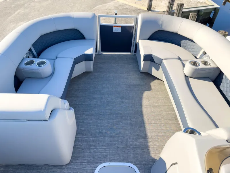 Slide: The Image of 2024 Bennington 22 LSB pontoon boat interior with plush seating and cup holders. - 11