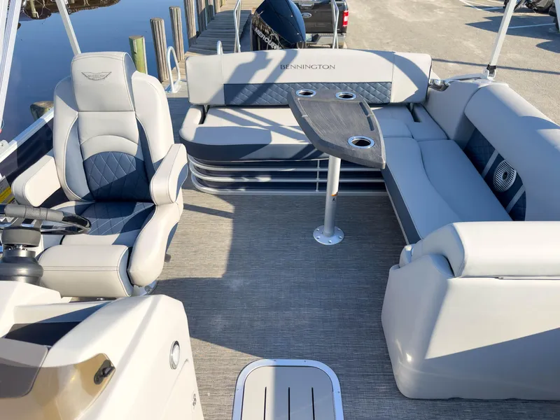 Slide: The Image of 2024 Bennington 22 LSB pontoon boat interior with plush seating and table. - 13
