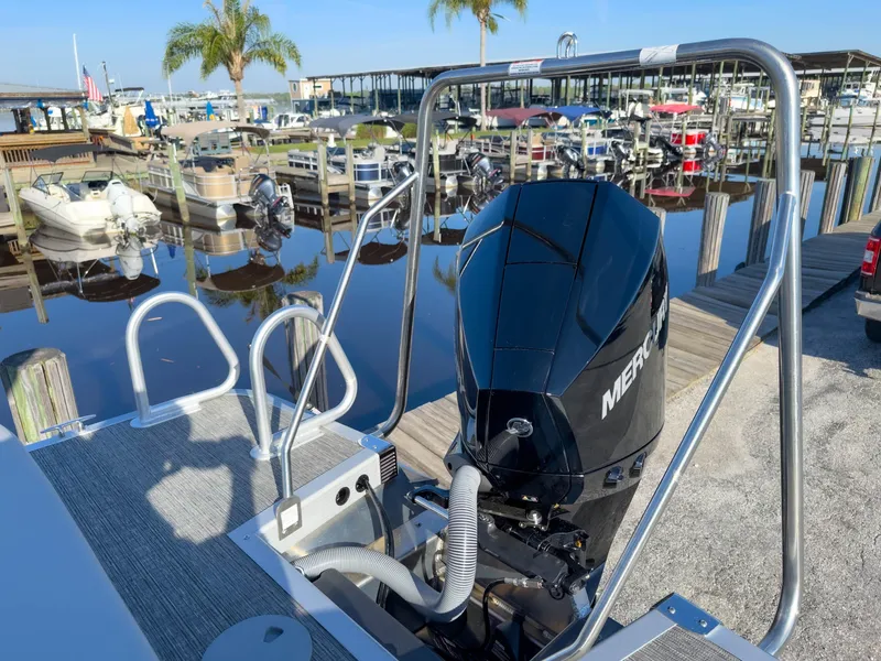 Slide: The Image of 2024 Bennington 22 LSB boat with Mercury engine at a marina dock. - 16