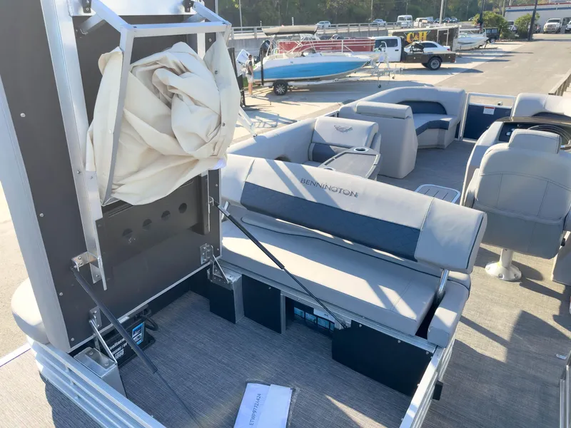 Slide: The Image of 2024 Bennington 22 LSB pontoon boat interior with seating and storage features. - 17