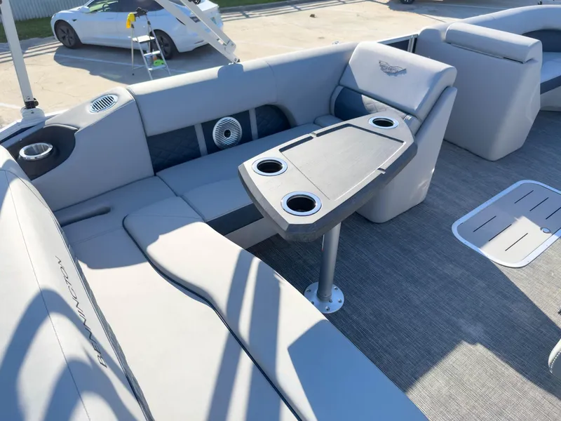 Slide: The Image of 2024 Bennington 22 LSB boat interior with seating and table, featuring cup holders. - 19