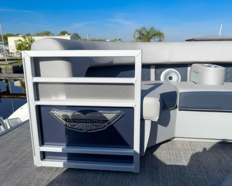 Slide: The Image of 2024 Bennington 22 LSB pontoon boat interior with seating and logo detail. - 27