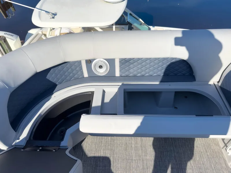 Slide: The Image of 2024 Bennington 22 LSB boat interior with cushioned seating and storage compartment. - 29