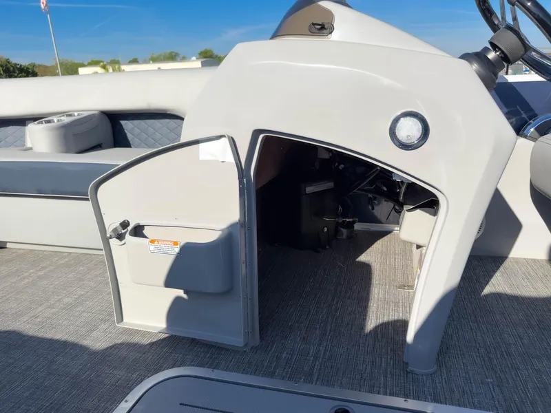 Slide: The Image of 2024 Bennington 22 LSB boat interior with open storage compartment and seating area. - 34