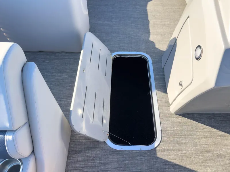Slide: The Image of 2024 Bennington 22 LSB boat interior with open storage compartment on deck. - 35