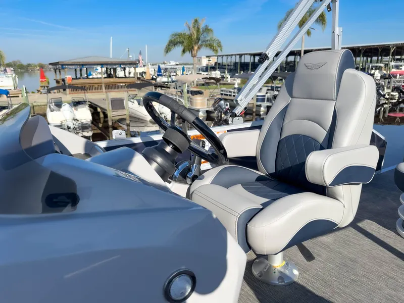 Slide: The Image of 2024 Bennington 22 LSB boat interior with luxurious captain's chair and steering wheel. - 36