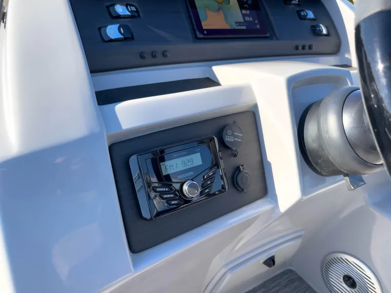Slide: The Image of 2024 Bennington 22 LSB boat dashboard with radio and control panel. - 38