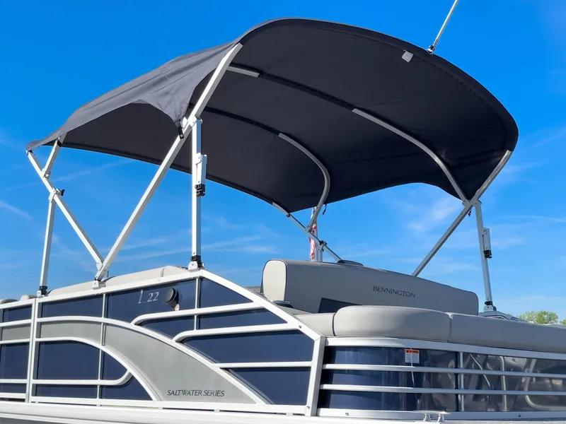 Slide: The Image of 2024 Bennington 22 LSB pontoon boat with canopy under clear blue sky. - 43