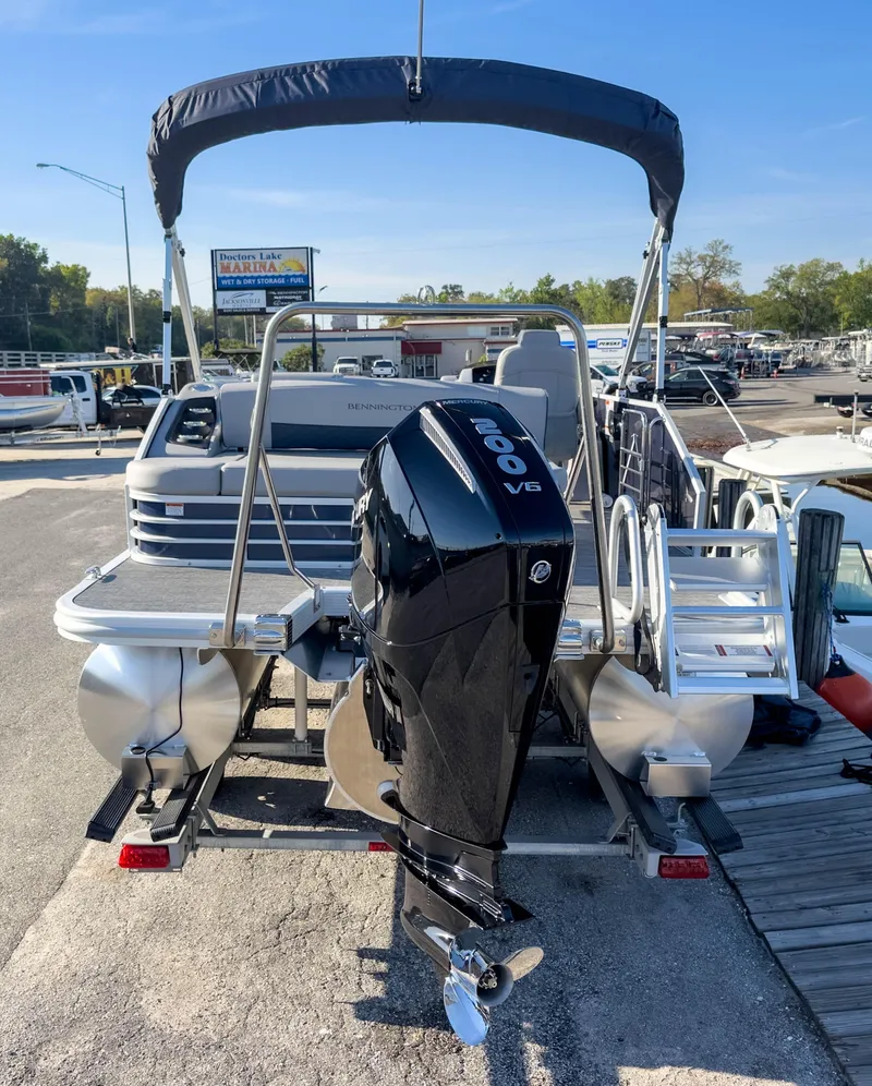Slide: The Image of 2024 Bennington 22 LSB pontoon boat with Mercury 200 V6 engine at marina. - 7