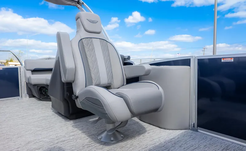 Slide: The Image of 2025 Bennington 22 MFB boat interior with luxurious gray seating under a blue sky. - 13