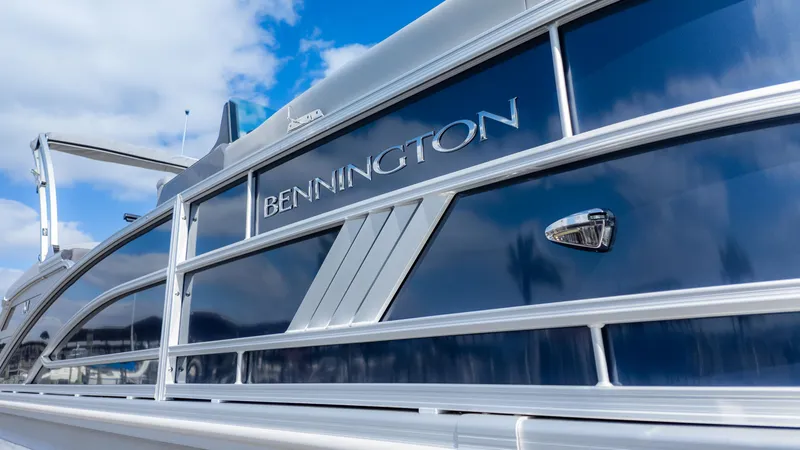 Slide: The Image of 2025 Bennington 22 MFB boat, sleek design with blue and silver accents. - 3