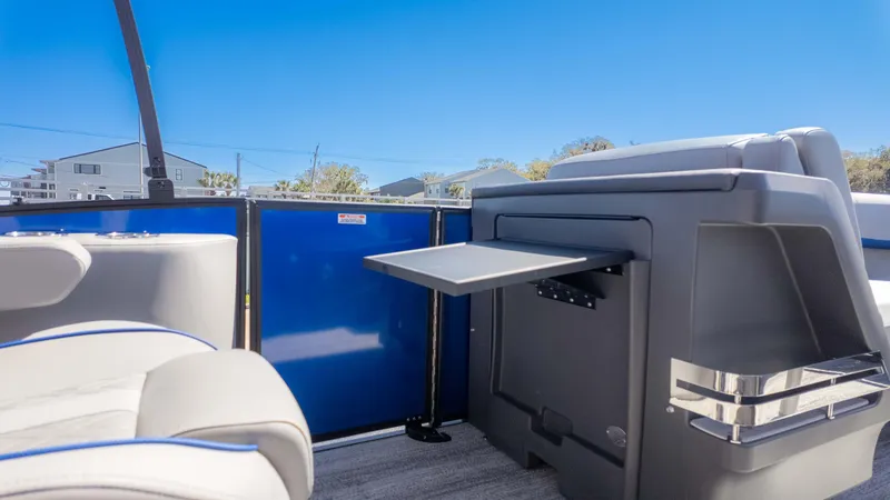 Slide: The Image of 2025 Bennington 22 MSB boat interior with seating and fold-out table. - 12