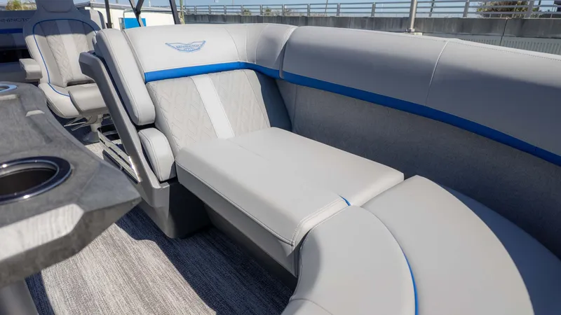 Slide: The Image of 2025 Bennington 22 MSB boat interior with luxurious gray seating and blue accents. - 14
