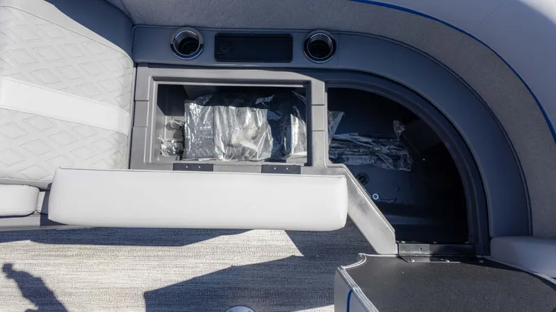 Slide: The Image of 2025 Bennington 22 MSB boat interior storage compartment with cup holders and seating. - 15