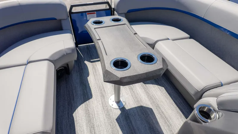Slide: The Image of 2025 Bennington 22 MSB boat interior with gray seating and table with cup holders. - 17