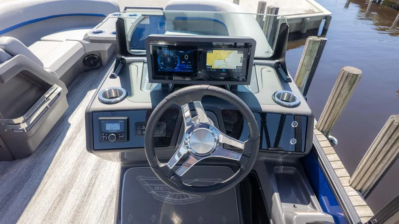 Slide: The Image of 2025 Bennington 22 MSB boat dashboard with steering wheel and navigation display. - 19