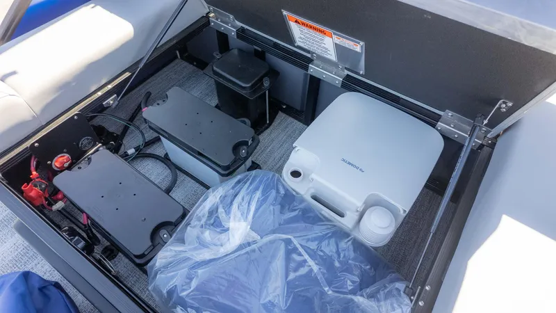 Slide: The Image of Storage compartment of 2025 Bennington 22 MSB boat with batteries and portable toilet. - 21