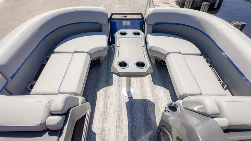 Slide: The Image of 2025 Bennington 22 MSB pontoon boat interior with plush seating and central table. - 9