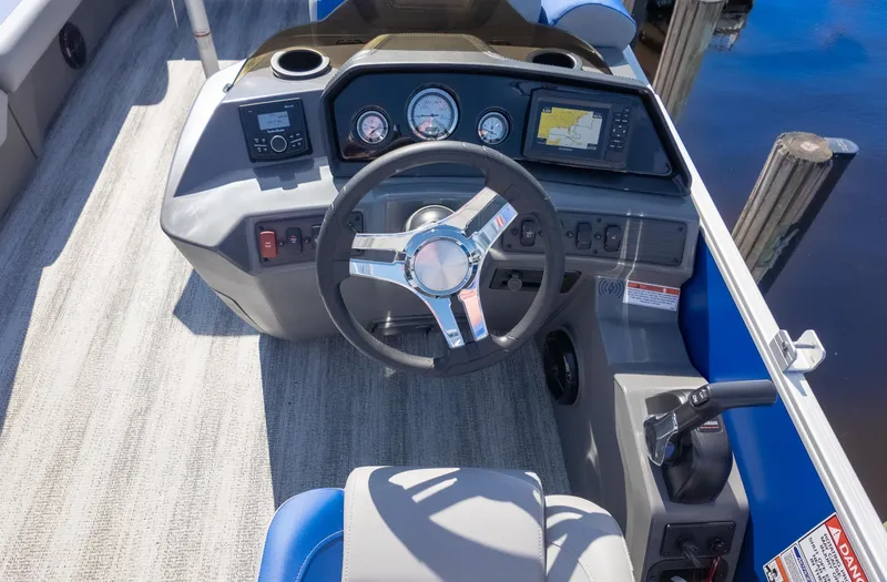 Slide: The Image of 2025 Bennington 22 SSR boat dashboard with steering wheel and navigation controls. - 19