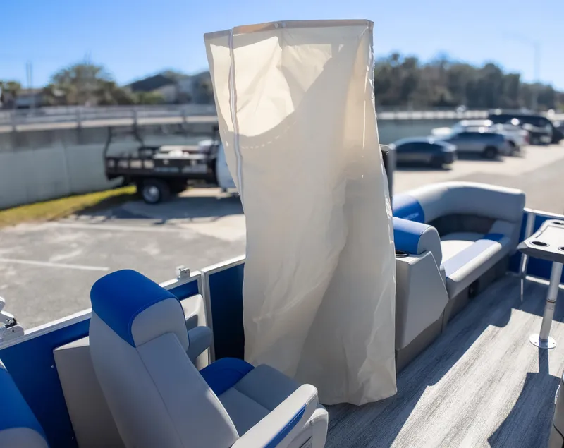 Slide: The Image of 2025 Bennington 22 SSR pontoon boat interior with seating and privacy curtain. - 20