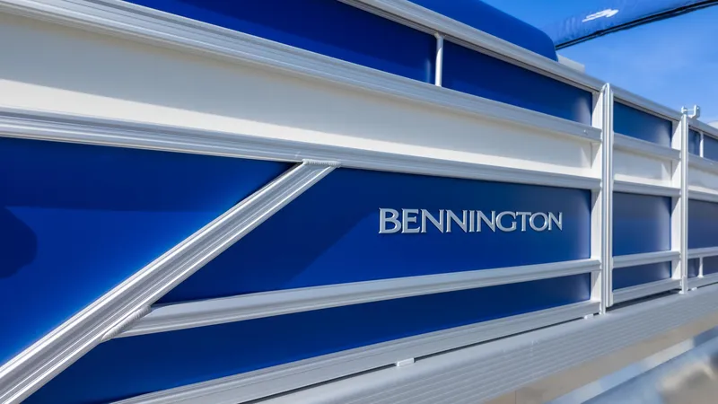 Slide: The Image of 2025 Bennington 22 SSR pontoon boat with sleek blue and white design. - 7