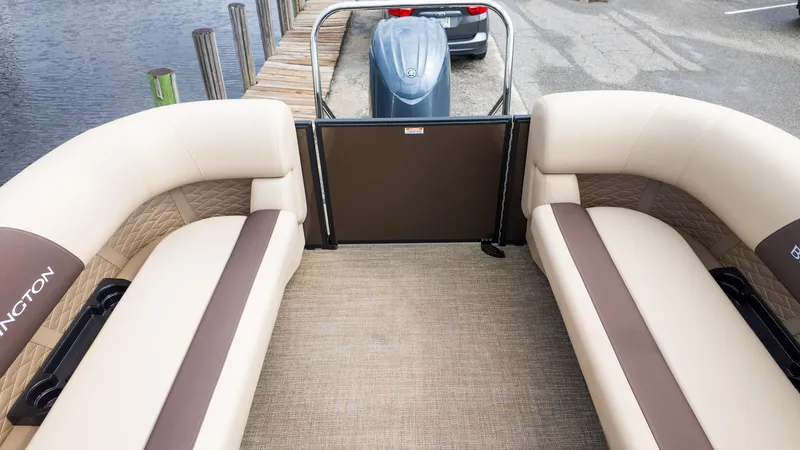 Slide: The Image of 2025 Bennington 22 SSR pontoon boat interior with beige seating and brown accents. - 11