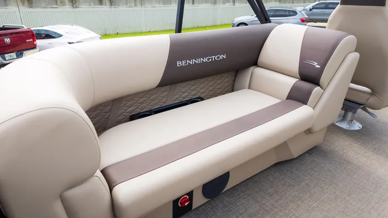 Slide: The Image of 2025 Bennington 22 SSR boat interior with beige and brown cushioned seating. - 14